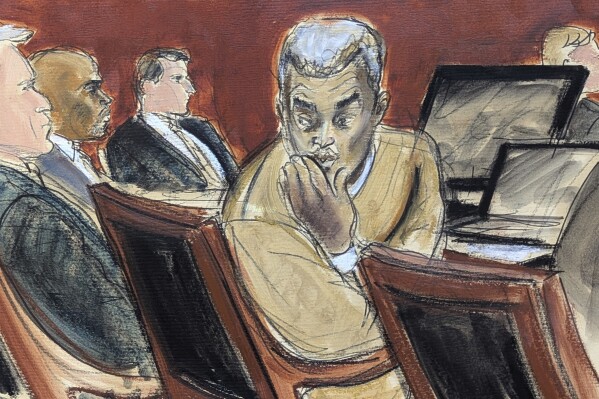 Sean "Diddy" Combs, right, blows kisses to people in the audience during his sex trafficking and racketeering trial in Manhattan federal court, Monday, May 19, 2025, in New York. (Elizabeth Williams via AP)