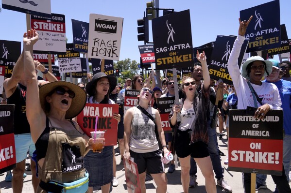 Striking writers and actors take part in a rally outside Paramount studios in Los Angeles on Friday, July 14, 2023. This marks the first day actors formally joined the picket lines, more than two months after screenwriters began striking in their bid to get better pay and working conditions. (AP Photo/Chris Pizzello)