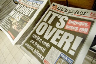 New York City's leading tabloids announce the end of the three-day transit strike in their Friday editions, Friday, Dec. 23, 2005. Social media users are falsely claiming that the New York Post published an article about an alleged bill that would make it illegal question the "official narrative" of 9/11. (AP Photo/Henny Ray Abrams)
