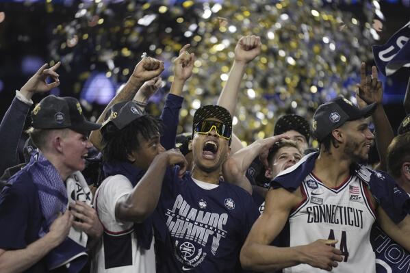 Connecticut players celebrate after the men's national championship college basketball game against San Diego State in the NCAA Tournament on Monday, April 3, 2023, in Houston. (AP Photo/Brynn Anderson)