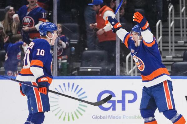 New York Islanders' Bo Horvat, right, celebrates with Simon Holmstrom after Holmstrom scored a goal during the third period of an NHL hockey game against the Winnipeg Jets Wednesday, Feb. 22, 2023, in Elmont, N.Y. The Islanders won 2-1. (AP Photo/Frank Franklin II)