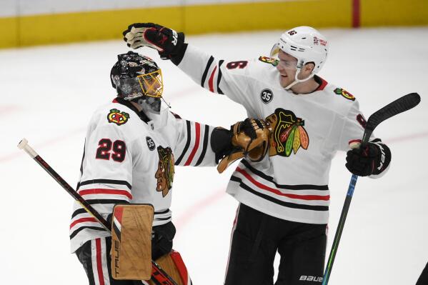 Chicago Blackhawks goaltender Marc-Andre Fleury (29) celebrates with right wing Mike Hardman (86) after the team's NHL hockey game against the Washington Capitals, Thursday, Dec. 2, 2021, in Washington. The Blackhawks won 4-3 in a shootout. (AP Photo/Nick Wass)