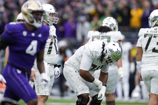 Oregon offensive lineman Charlie Pickard (70) and offensive lineman Steven Jones, center, react after a missed field goal by Camden Lewis on the final play of the team's loss to Washington in an NCAA college football game, Saturday, Oct. 14, 2023, in Seattle. (AP Photo/Lindsey Wasson)