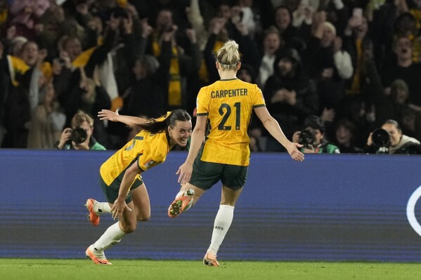 Australia's Hayley Raso, left, celebrates her side's second goal during the Women's World Cup round of 16 soccer match between Australia and Denmark at Stadium Australia in Sydney, Australia, Monday, Aug. 7, 2023. (AP Photo/Mark Baker)