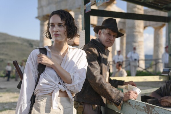 This image released by Lucasfilm shows Phoebe Waller-Bridge, left, and Harrison Ford in a scene from "Indiana Jones and the Dial of Destiny." (Lucasfilm Ltd. via AP)