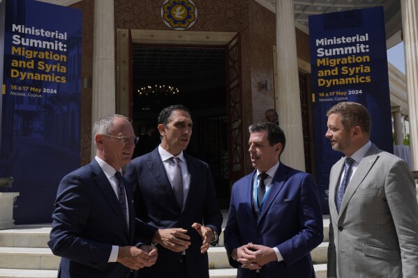 Cyprus' interior minister Konstantinos Ioannou, second left, talks with his counterparts Austria's Gerhard Karner, left, Czech's Vít Rakusan, right, and Greece's Minister Of Immigration and Asylum Dimitris Kairides, second right, stand by, during the Ministerial Summit Migration and Syria Dynamics in capital Nicosia, Cyprus, Friday, May 17, 2024. The governments of eight European Union member states say the situation inside Syria should be re-evaluated to allow for voluntary returns of Syrian refugees back to their homeland. (AP Photo/Petros Karadjias)