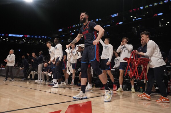 Duquesne forward Dusan Mahorcic (0) reacts with teammates on the bench during the first half of an NCAA college basketball game against Dayton in the quarterfinals of the Atlantic 10 tournament Thursday, March 14, 2024, in New York. (AP Photo/Peter K. Afriyie)