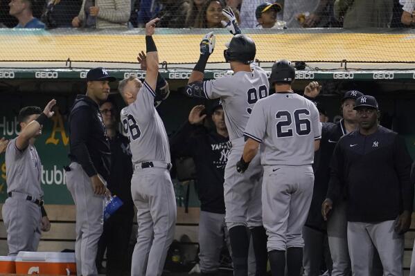 New York Yankees' Aaron Judge, middle, celebrates with teammates after hitting a three-run home run against the Oakland Athletics during the fifth inning of a baseball game in Oakland, Calif., Friday, Aug. 26, 2022. (AP Photo/Jeff Chiu)