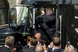 FILE - In this March 23, 2017, file photo President Donald Trump honks the horn of an 18-wheeler truck while meeting with truckers and CEOs regarding healthcare on the South Lawn of the White House in Washington. Trump publicly acknowledged that humans bear some blame for climate change, but scientists say the president still isn't dealing with the reality of our primary role. Trump said Tuesday, Sept. 29, 2020, that humans — their tailpipe exhaust, oil and gas production, and smokestack fumes — are just one of many culprits for the weather-disrupting deterioration of Earth’s atmosphere. (AP Photo/Andrew Harnik, File)