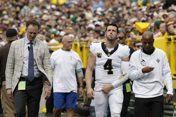 New Orleans Saints quarterback Derek Carr (4) walks to the locker room after being injured during the second half of an NFL football game against the Green Bay Packers Sunday, Sept. 24, 2023, in Green Bay, Wis. (AP Photo/Matt Ludtke)