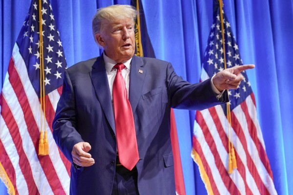 FILE - Former President Donald Trump gestures after speaking during the North Carolina Republican Party Convention in Greensboro, N.C., June 10, 2023. The latest indictment of Donald Trump alleges the former president conspired to overturn the will of voters and disrupt the peaceful transfer of power. Yet Trump's most devoted followers claim these serious criminal charges actually show that Trump is the victim of political persecution. (AP Photo/Chuck Burton, File)