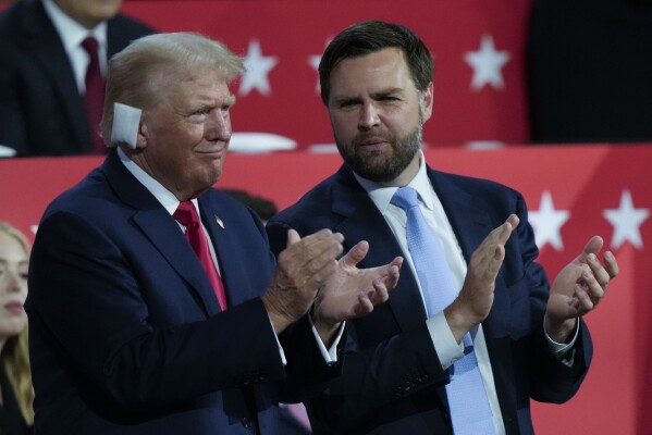 Republican presidential candidate former President Donald Trump and Republican vice presidential candidate Sen. JD Vance, R-Ohio, applaud during the Republican National Convention Monday, July 15, 2024, in Milwaukee. (AP Photo/Charles Rex Arbogast)