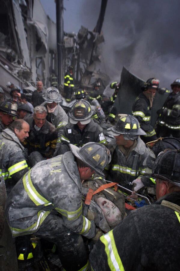 A fireman screams in pain as he is rescued shortly after both towers of New York's World Trade Center collapsed following a terrorist attack, Tuesday, Sept. 11, 2001. (Robert Mecea/Newsday via AP)