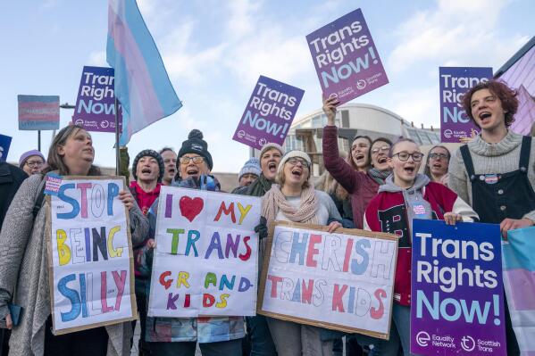 Supporters of the Gender Recognition Reform Bill (Scotland) take part in a protest outside the Scottish Parliament, ahead of a debate on the bill, in Edinburgh. Tuesday, Dec. 20, 2022. A plan by Scotland’s government to make it easier for people to change gender has sparked acrimonious debate, with lawmakers arguing inside the Edinburgh parliament and rival groups of protesters demonstrating outside. A bill introduced by the Scottish National Party-led government will allow people to change gender by self-declaration, removing the need for a medical diagnosis of gender dysphoria. (Jane Barlow/PA via AP)