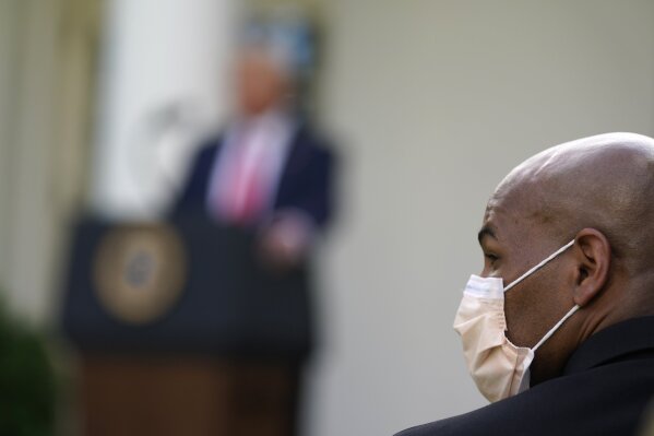 U.S. Surgeon General Jerome Adams listens as President Donald Trump answers questions from reporters during an event on protecting seniors with diabetes in the Rose Garden White House, Tuesday, May...