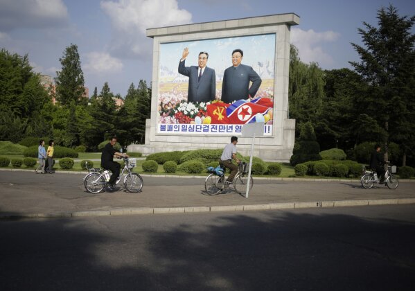 
              Cyclists ride past an image of North Korean leaders Kim Il-sung and Kim Jong Il in Pyongyang, North Korea, Tuesday, June 12, 2018. President Donald Trump and North Korea's Kim Jong Un concluded an extraordinary nuclear summit Tuesday with the U.S. president pledging unspecified "security guarantees" to the North and Kim recommitting to the "complete denuclearization of the Korean Peninsula." (AP Photo/Dita Alangkara)
            
