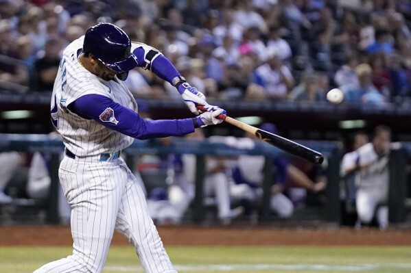 Arizona Diamondbacks' Lourdes Gurriel Jr. connects for a two-run home run against the San Diego Padres during the seventh inning of a baseball game Sunday, Aug. 13, 2023, in Phoenix. (AP Photo/Ross D. Franklin)