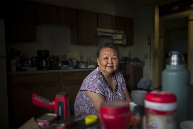 Vera Manutoli poses for a portrait inside her home, Sunday, Aug. 20, 2023, in Akiachak, Alaska. (AP Photo/Tom Brenner)