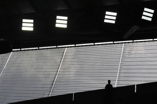 A fan watches from the top of the stands during a second-round match between Aryna Sabalenka of Belarus and Switzerland's Jil Teichmann during the French Tennis Open at the Roland-Garros stadium in Paris, Wednesday, May 28, 2025. (AP Photo/Lindsey Wasson)