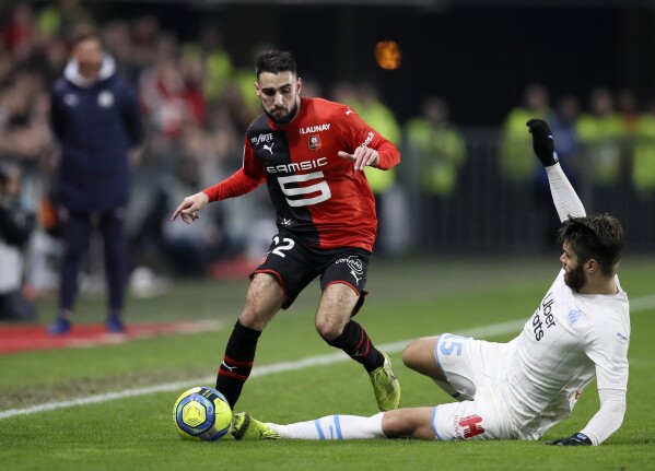Rennes' Romain Del Castillo, left, duels for the ball with Marseille's Duje Caleta-Car during the League One soccer match between Rennes and Marseille, at the Roazhon Park stadium in Rennes, France, Friday, Jan. 10, 2020. With the traditional powerwhouses taking a rest, it's a mouthwatering contest between surprise package Brest and a resugent Lyon side that takes the spotlight in the French league this weekend. (AP Photo/David Vincent)