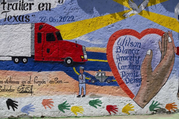 A list of young migrants who died asphyxiated in 2022 in a smuggler's trailer truck in San Antonio, Texas, covers a wall in their hometown of Comitancillo, Guatemala, Tuesday, March 19, 2024. Tens of thousands of youth from this region would rather take deadly risks, even repeatedly, than stay behind where they see no future. (AP Photo/Moises Castillo)