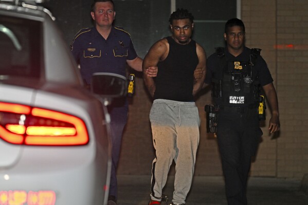 Troopers with Louisiana State Police escort Orleans Parish Prison escapee Lenton Vanburen to a waiting vehicle late Monday, May 26, 2025, at Louisiana State Police Headquarters after he was captured in Baton Rouge, La. (Hilary Scheinuk/The Advocate via AP)