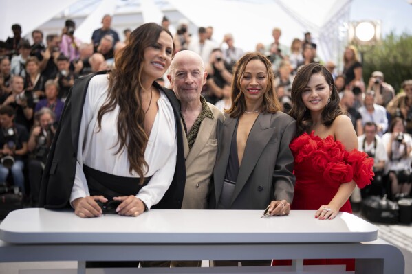 FILE - Karla Sofia Gascon, from left, Jacques Audiard, Zoe Saldana and Selena Gomez pose for photographers at the photo call for the film "Emilia Perez" at the 77th international film festival, Cannes, southern France, on May 19, 2024. (Photo by Scott A Garfitt/Invision/AP, File)