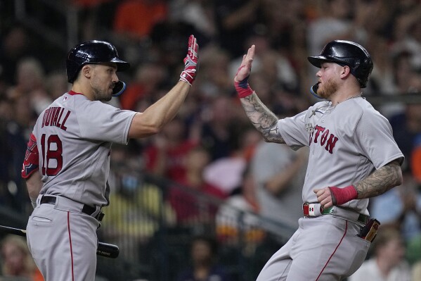 Adam Duvall of the Boston Red Sox is congratulated in the dugout