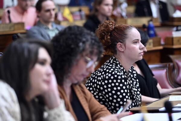 In this image provided by the WV Legislative Photography, Catherine Jones watches people speak during public hearing in the House of Delegates Chamber for a bill that would codify the right of West Virginia residents to challenge government regulations that interfere with their religious beliefs, Friday, Feb. 24, 2023, at the West Virginia State Capitol in Charleston, W.Va. Jones, a gay woman who spoke against the bill, said it is going to do nothing but "legalize discrimination against already marginalized communities." (Perry Bennett/WV Legislative Photography via AP)