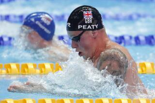 Britain's Adam Peaty swims in his heat of the men's 100m breaststroke at the World Swimming Championships in Gwangju, South Korea, Sunday, July 21, 2019. (AP Photo/Lee Jin-man)