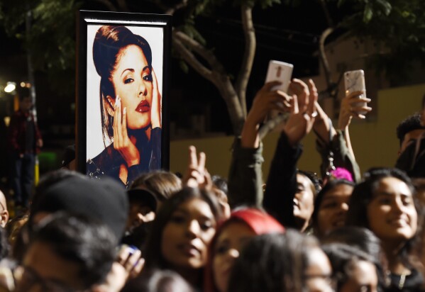 A portrait of the late singer Selena Quintanilla is seen in the crowd following a posthumous star ceremony for Quintanilla on the Hollywood Walk of Fame on Friday, Nov. 3, 2017, in Los Angeles. (Photo by Chris Pizzello/Invision/AP, File)