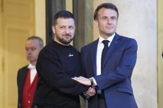 FILE - French President Emmanuel Macron, right, welcomes Ukrainian President Volodymyr Zelenskyy at the Elysee palace in Paris, May 14, 2023. French President Emmanuel will sign a bilateral security agreement with Ukrainian President Volodymyr Zelenskyy on Friday Feb.16, 2024 in Paris as part of a trip to Germany and France, the French presidency said in a statement. (AP Photo/Michel Euler, File)