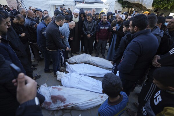 Palestinians mourn their relatives killed in the Israeli bombardments of the Gaza Strip in front of the morgue of the Al Aqsa Hospital in Deir al Balah, on Thursday, Feb. 29, 2024. (AP Photo/Adel Hana)