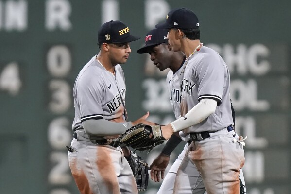 New York Yankees outfielders Everson Pereira, left, Estevan Florial, center, and Oswaldo Cabrera celebrate after the Yankees defeated the Boston Red Sox in the second game of a baseball doubleheader Tuesday, Sept. 12, 2023, in Boston. (AP Photo/Steven Senne)