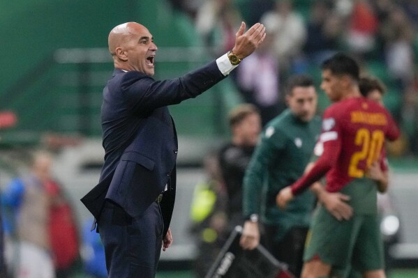 FILE - Portugal coach Roberto Martinez gestures during the Euro 2024 group J qualifying soccer match between Portugal and Iceland, at the Alvalade Stadium in Lisbon, Sunday, Nov. 19, 2023. The European Championship represents an opportunity for player Cristiano Ronaldo to remind soccer fans that he is still a force in the game. Portugal coach Roberto Martinez, who was hired weeks after the World Cup, has retained the 39-year-old Ronaldo as captain. (AP Photo/Armando Franca, File)