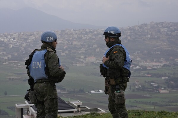FILE - Spanish U.N. peacekeepers stand on a hill overlooking the Lebanese border villages with Israel in Marjayoun town on Wednesday, Jan. 10, 2024. A war of words that has unfolded in Lebanon show longstanding schisms in the small country over Hezbollah, now amplified by the militant group's role in the Lebanon-Israel border clashes and by fears that an already crisis-hit Lebanon could be dragged into an all-out war. (AP Photo/Hussein Malla, File)