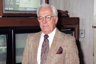 This photo provided by Equi-Photo shows former jockey and New Jersey State steward Sam Boulmetis, Sr. poses in the Stewards Office at Monmouth Park Racetrack in Oceanport, N.J., in this June 11, 1995, photo. Boulmetis Sr., a Hall of Fame jockey for nearly 20 years who won most of his four riding titles at New Jersey's Monmouth Park in the 1950s, has died. He was 94. He died Sunday, May 30, 2021, at Riverview Medical Center in Red Bank, his family said. (Bill Denver/Equi-Photo via AP)