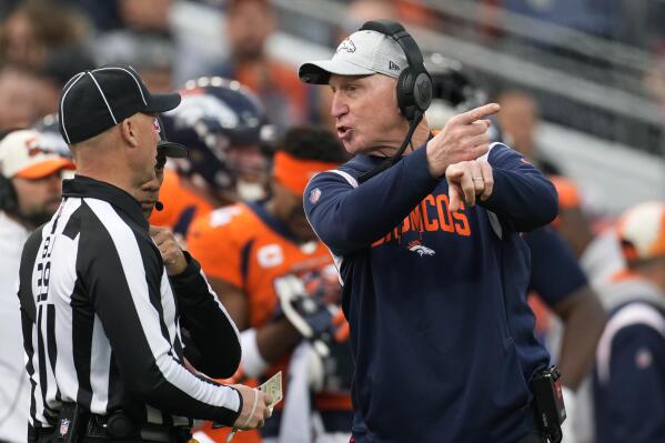 Denver Broncos head coach Jerry Rosburg, right, talks with an official during the first half of an NFL football game against the Los Angeles Chargers in Denver, Sunday, Jan. 8, 2023. (AP Photo/David Zalubowski)
