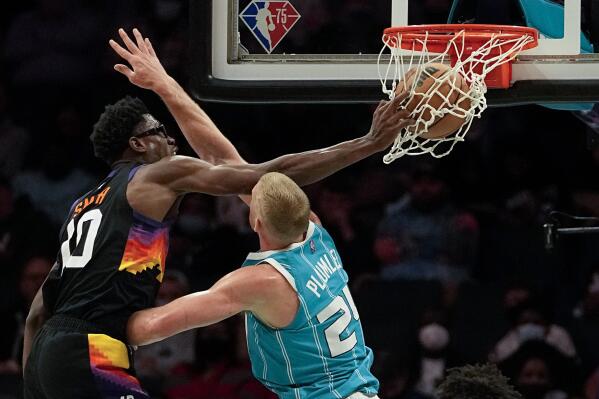 Phoenix Suns forward Jalen Smith dunks over Charlotte Hornets center Mason Plumlee during the second half of an NBA basketball game on Sunday, Jan. 2, 2022, in Charlotte, N.C. (AP Photo/Chris Carlson)