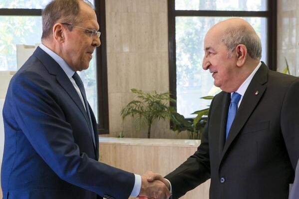In this photo released by Russian Foreign Ministry Press Service, Algerian President Abdelmadjid Tebboune, right, greets Russian Foreign Minister Sergey Lavrov during their meeting at El Mouradia Palace, the official residence of the President, in Algiers, Algeria, on Tuesday, May 10, 2022. (Russian Foreign Ministry Press Service via AP)