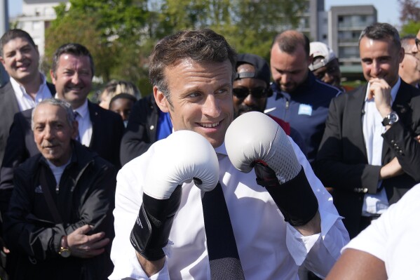 FILE - Centrist presidential candidate and French President Emmanuel Macron wears boxing gloves as he campaigns in the Auguste Delaune stadium, Thursday, April 21, 2022, in Saint-Denis, outside Paris, France. (ĢӰԺ Photo/Francois Mori, Pool, File)