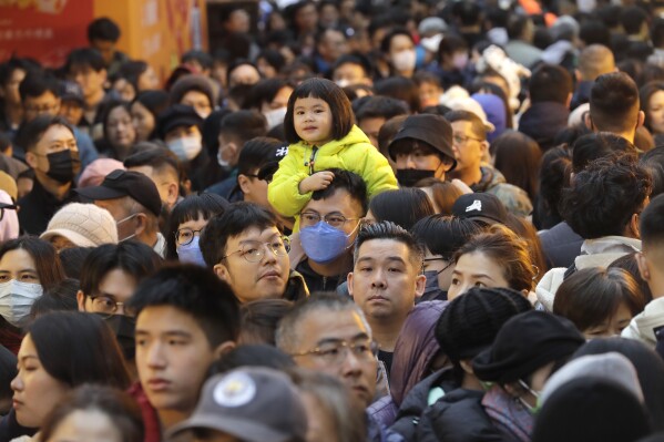 Shoppers crowd for the upcoming Lunar New Year celebrations at the Dihua street market in Taipei, Taiwan, Thursday, Feb. 8, 2024. (AP Photo/Chiang Ying-ying)