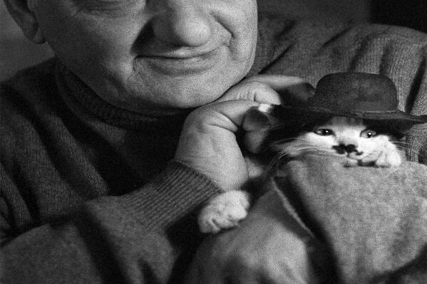 Rezo Gabriadze, a legendary Georgian theater director and film screenwriter who has won broad fame across the former Soviet Union for movies he wrote poses for a photo in Tbilisi, Georgia, in 2006. Rezo Gabriadze has died in Tbilisi, Georgia. He was 84. His relatives and colleagues said he died on Sunday of an unspecified illness. Garbriadze, an iconic figure in the former Soviet Union, worked as a screenwriter for numerous movies, including Mimino and Kin-Dza-Dza, the cult comedies by Georgian director Georgiy Daneliya. (AP Photo/Yuriy Rost)