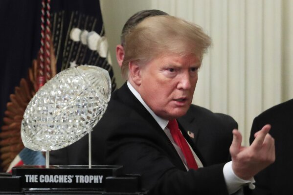 
              President Donald Trump calls an invited guest to join them on the stage during a ceremony welcoming the 2018 college football playoff National Champion Clemson Tigers to the White House in Washington, Monday, Jan. 14, 2019. (AP Photo/Manuel Balce Ceneta)
            