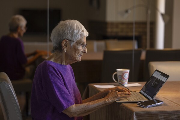 Barbara Winston uses a computer at her home in Northbrook, Ill., on Sunday, June 30, 2024, several days after taking an introduction to artificial intelligence class at a local senior center. “I saw ice boxes turn into refrigerators, that is how long I have been around, ... And I think [AI] is probably the greatest technical revolution that I will see in my lifetime,” she says. (AP Photo/Teresa Crawford)