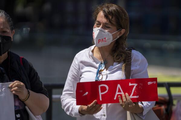 A woman attends a memorial of all priests and religious men and women who have been murdered in Mexico, in Mexico City, Sunday, July 10, 2022. In the wake of the murders of two Jesuit priests two weeks ago in Chihuahua, the Society of Jesus and other religious institutions called for a day of prayer and peace. (AP Photo/Moises Castillo)