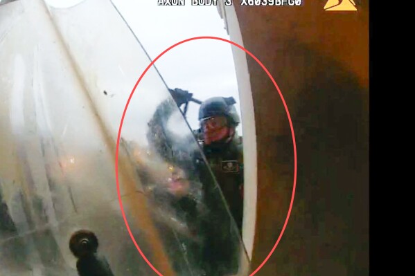 This image from police body-worn camera video, contained and annotated in the Justice Department's statement of facts, supporting the arrest warrant for Edward Richmond Jr., at the U.S. Capitol on Jan. 6, 2021, in Washington. Richmond, a former U.S. Army soldier who was convicted of manslaughter for fatally shooting a handcuffed cowherd in Iraq, was ordered jailed Jan. 30, 2024, on charges that he used a metal baton to assault police officers during a mob's attack on the U.S. Capitol on Jan. 6, 2021.(Department of Justice via AP)