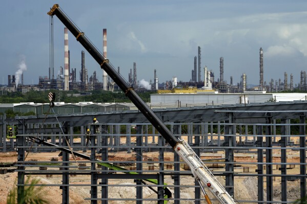Employees work at a BYD vehicle factory being built in Camacari, Bahia state, Brazil, Thursday, March 6, 2025. (AP Photo/Eraldo Peres)