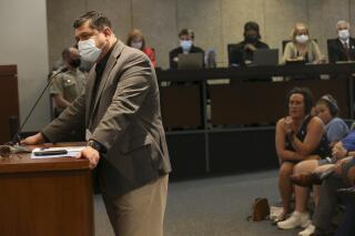 St. Louis County Health Director Dr. Faisal Khan answers questions posed by council members regarding the St. Louis County mask mandate during a St. Louis County Council meeting on Tuesday, July 27, 2021, in Clayton., Mo. Khan said he was called racial slurs and physically assaulted during the meeting after defending the newly imposed mask mandate to combat COVID-19.  (Laurie Skrivan/St. Louis Post-Dispatch via AP)