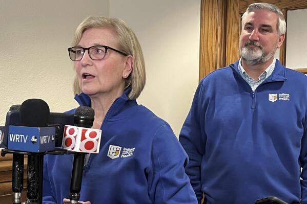 Indiana State Health Commissioner Dr. Kristina Box, left, speaks with reporters alongside Gov. Eric Holcomb about a proposed expansion of county public health services at the Indiana Statehouse in Indianapolis on Thursday, Jan. 26, 2023. A state Senate committee voted Wednesday to endorse a bill laying out the responsibilities that local health departments would have under the proposal. (AP Photo /Tom Davies)